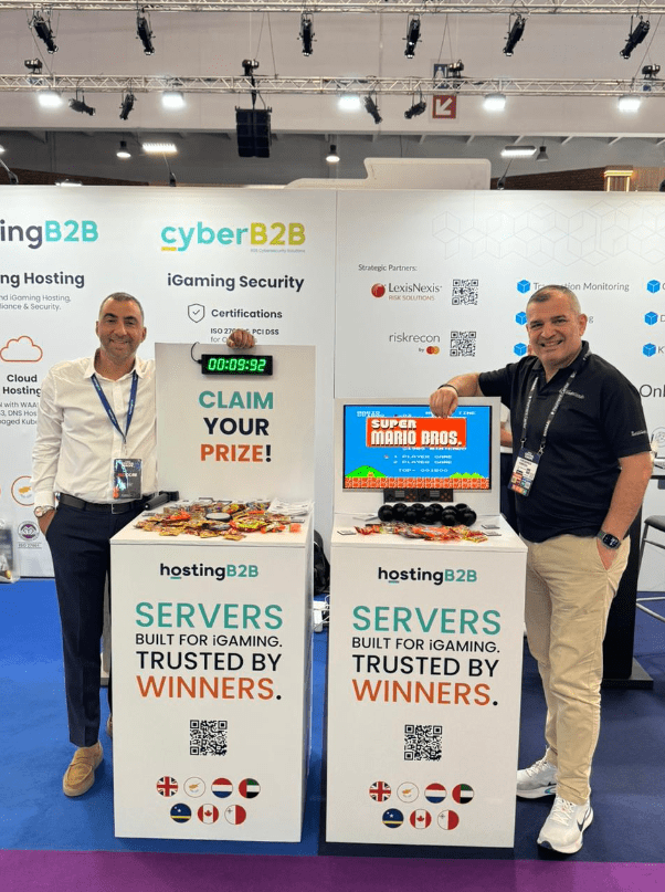 Infocredit Director, Theodoros Kringou and HostingB2B, Flutter Networks, and CyberB2B director George Sarris standing next to the show stoppers of SiGMA Central Europe! Super Mario Bros and the Buzzer box.